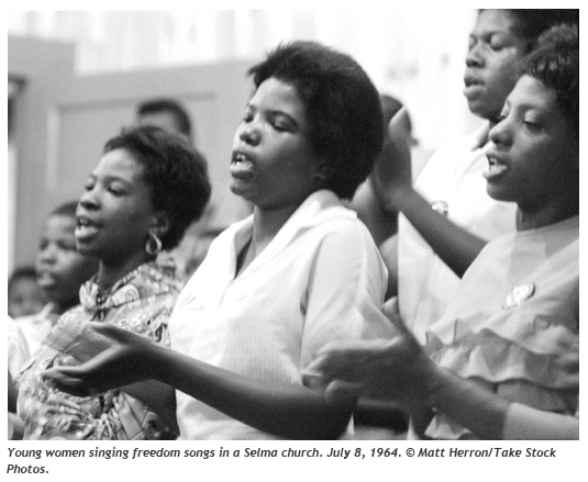 Young women singing freedom songs in a Selma church. 7/8/1964. (c) Matt Herron/Take Stock Photos.