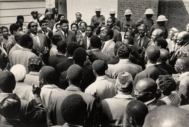 Nelson Mandela and friends sing 'Nikosi Sikelel I Afrika' at the end of their trial for treason in South Africa.