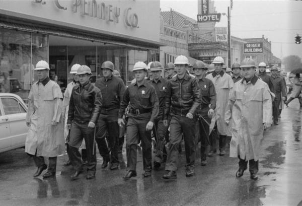 "Riot squad" on January 22, 1964 marching down Pine Street to courthouse where citizens plan to register to vote.