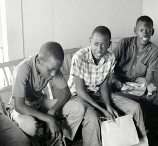 From the Randall (Herbert) Freedom Summer Photographs. Photograph (positive image of a negative) of a group of children from the Mobile Street area participating in a Freedom School class in Hattiesburg, Mississippi, during Freedom Summer, 1964. Second from the left is Charles Ray Leggett, and the other boys are Pete Jordan, Chip Benton, and a boy whose last name is Goudy.